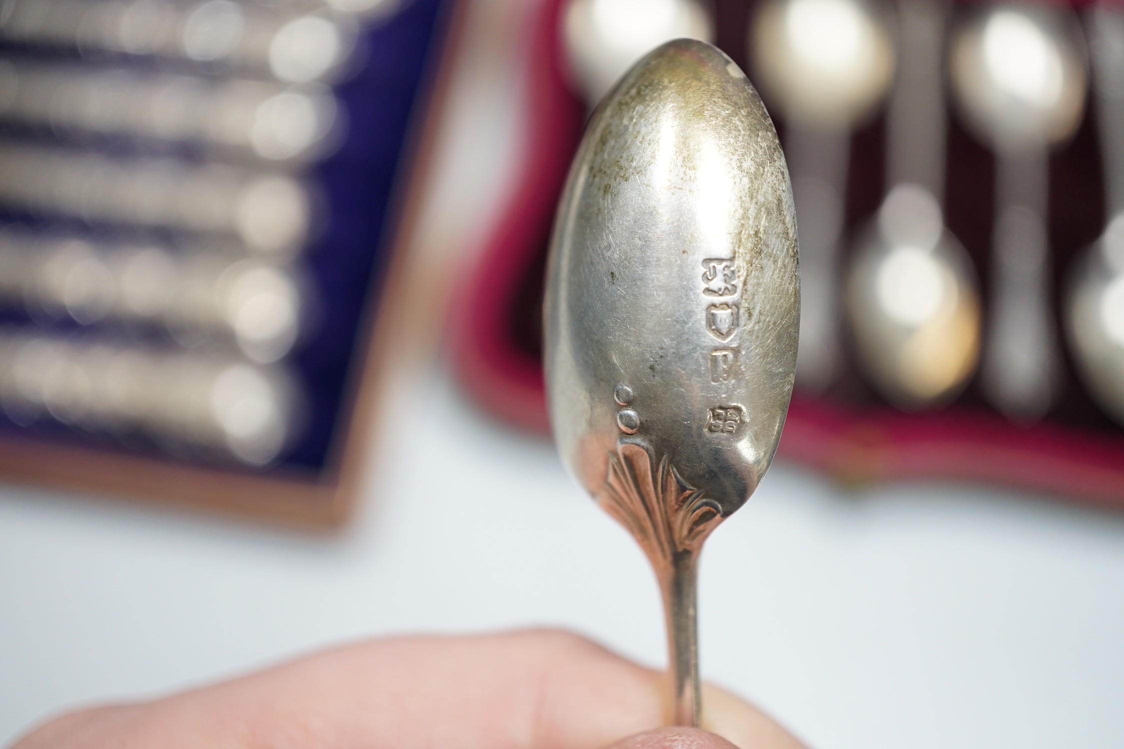 A set of six teaspoons, London, 1910, a set of six silver coffee spoons, six silver handled tea knives, all cased.